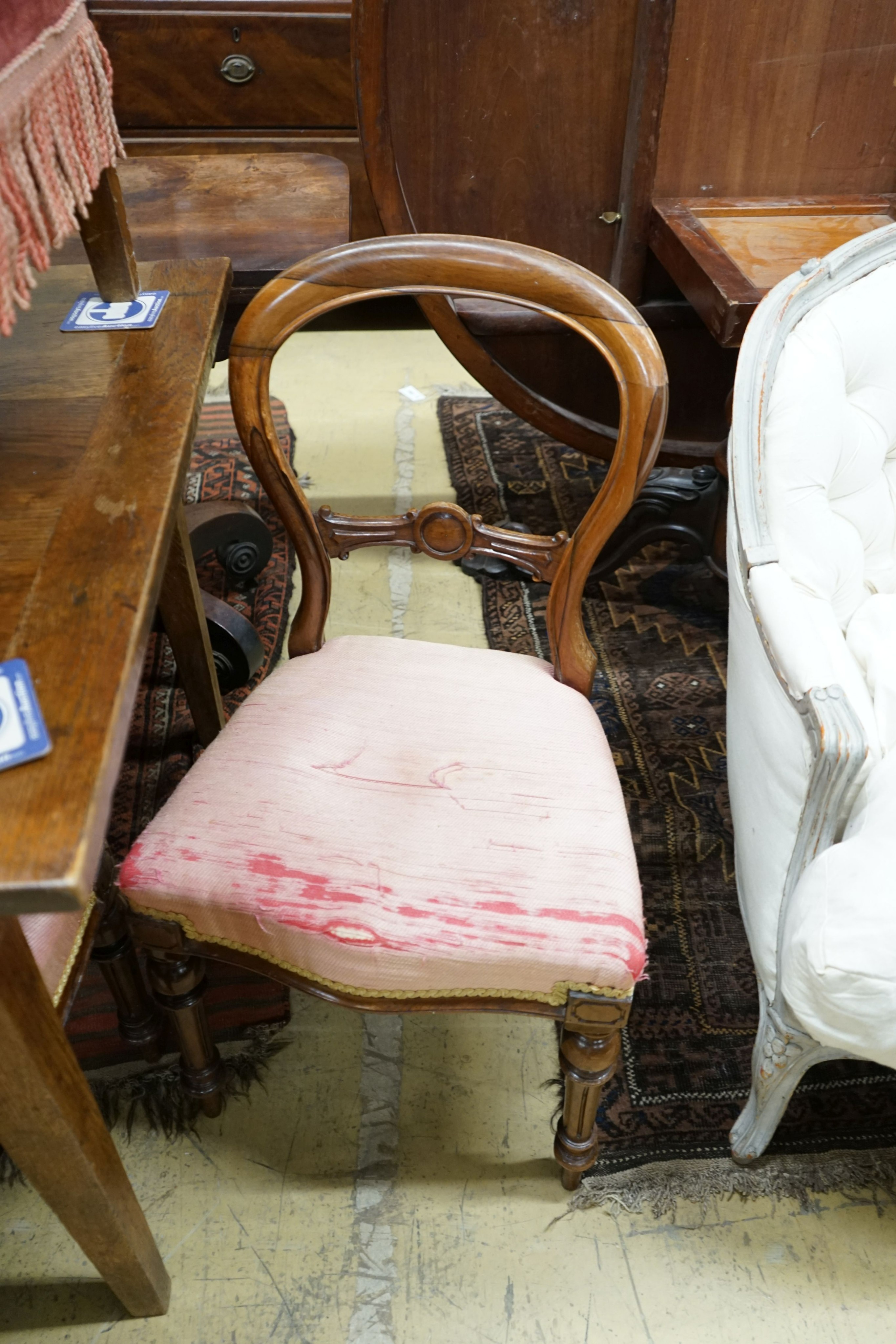 A set of four Victorian rosewood balloon back dining chairs